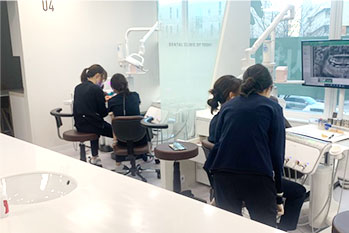 The team working side by side at the shared clinical workstation.
